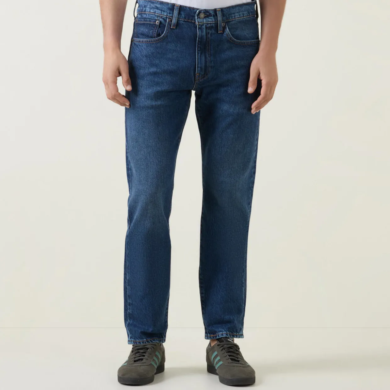502™ Mid-Rise Tapered Jeans